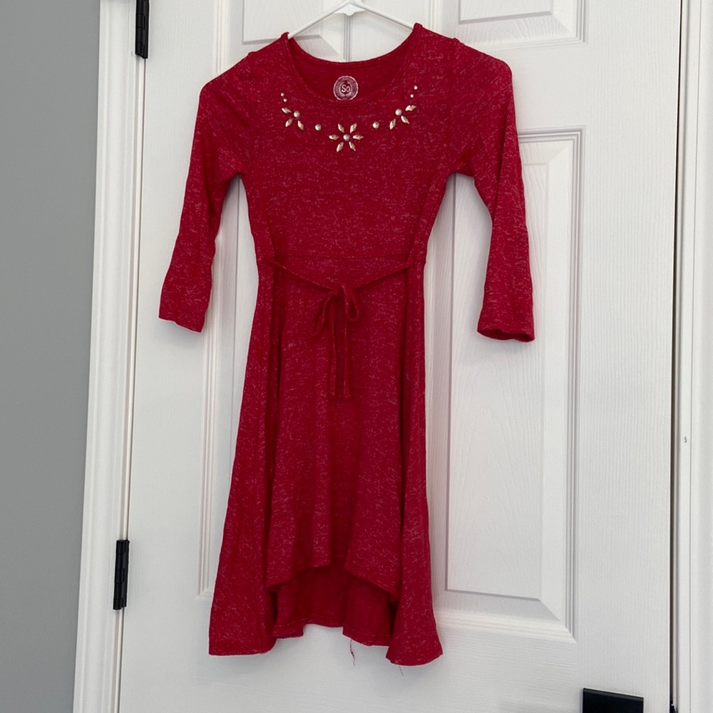 Red longs sleeve dress with jewel adorned neckline.